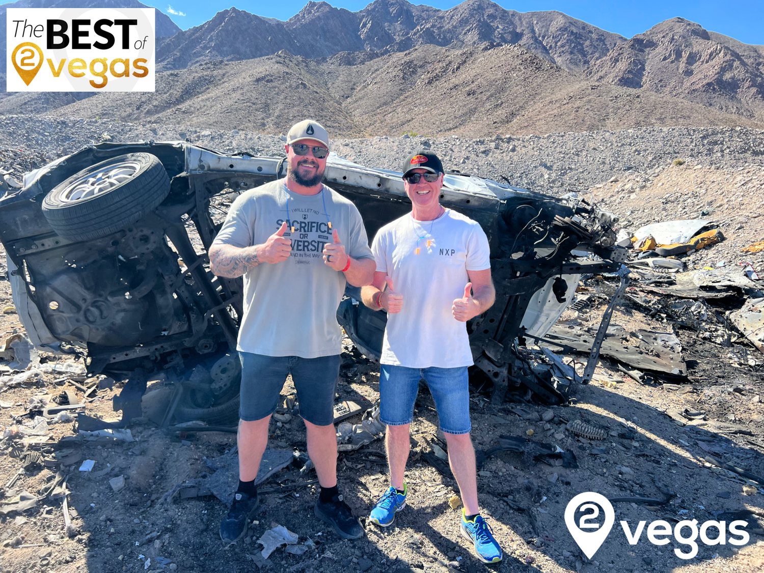 2 Very Happy guests with the remains of a Car they just blew up with 2Vegas.com